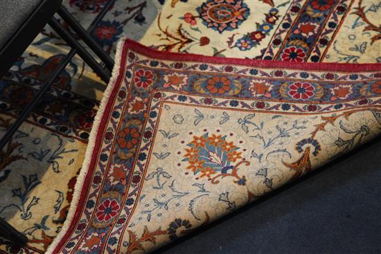 A Kashan ivory ground carpet, 14ft 3in by 10ft 7in.
